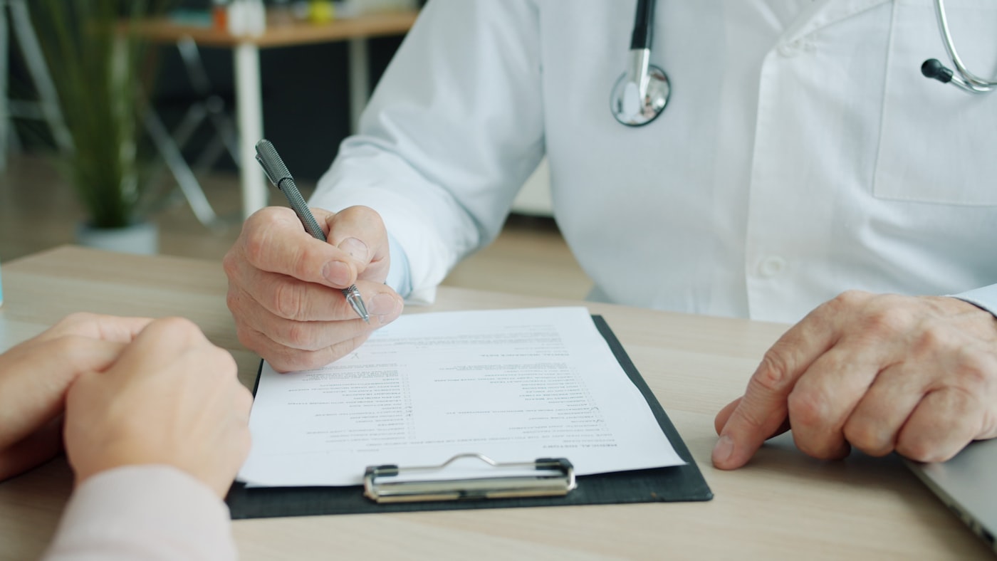 A GP completing a patient referral
