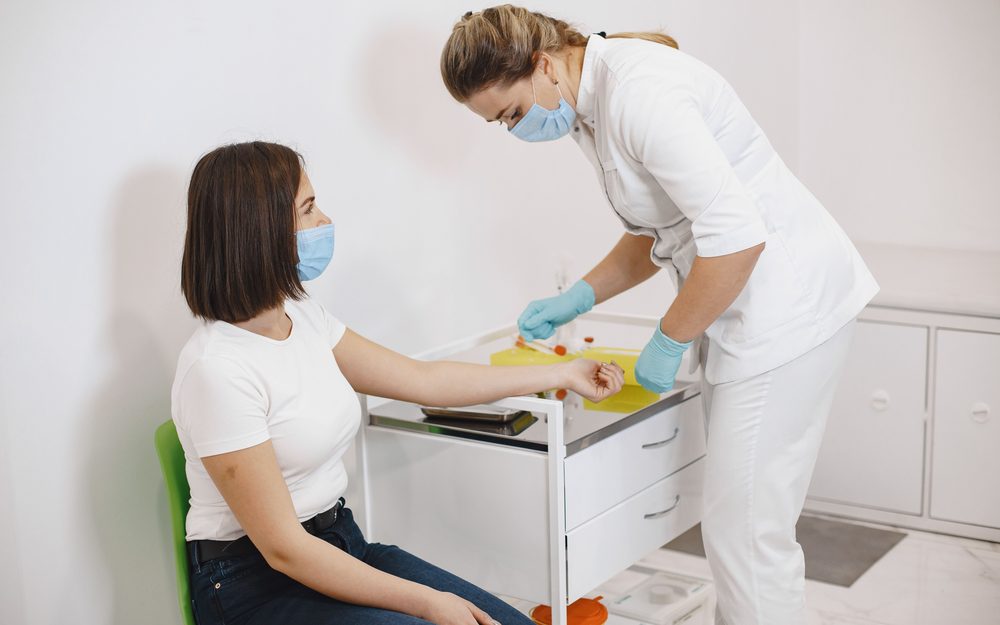 A patient having a blood sample taken for hormonal testing